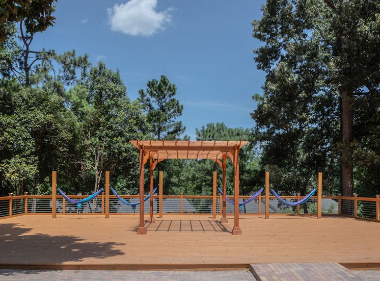 view of trees and sundeck with hammocks at Magnolia Crossing in Macon GA